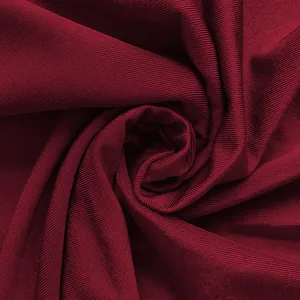 Macro view of dark red ribbed knit fabric textured like a rose for elegant dress