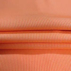 High-quality close-up showing the texture of vibrant orange ribbed knit fabric for apparel