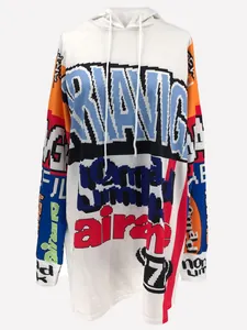 Detail view of a white oversized hoodie dress featuring colorful pixelated letter prints.