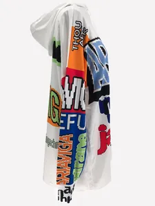 Side detail of white oversized hoodie dress featuring colorful pixelated graphic prints.