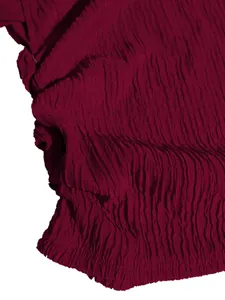 Detailed macro shot of high-quality burgundy pleated fabric texture for elegant skirt set