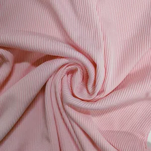 Detailed macro shot of soft pink ribbed knit fabric texture for a stylish jumpsuit