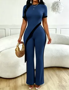 Close-up of a stylish blue two-piece set featuring a diagonal cutout top and wide-leg pants