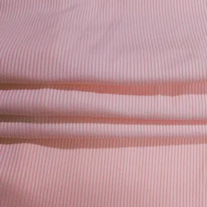 Close-up macro view showing texture of pink ribbed knitted stretch fabric jumpsuit