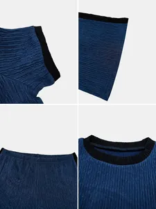 Macro view of blue textured pleated fabric with black contrast collar and edges.