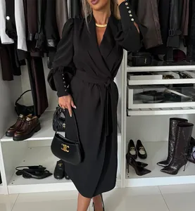Elegant black long-sleeved wrap dress with a shawl collar and waist tie detail.