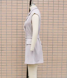 Side profile view of a lavender sleeveless blazer dress on a professional mannequin
