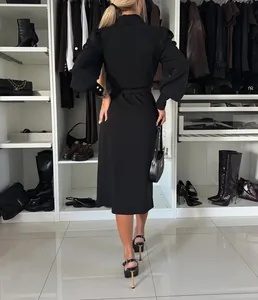 Back view detail of elegant black shawl collar long sleeve belted midi dress on model