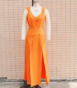 Detail view of vibrant orange two-piece sleeveless maxi dress with high slits