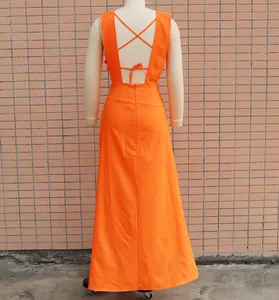 Detailed back view of an orange sleeveless dress featuring elegant crisscross strap design