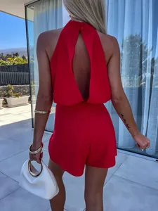 Back view of a red sleeveless halter romper with elegant backless cut and high waist