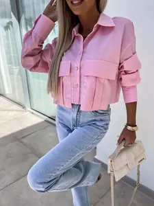 Close-up of a pink batwing sleeve loose shirt with large utility pockets