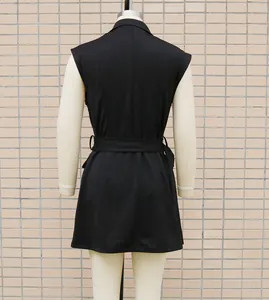 Back view of a minimalist sleeveless black blazer dress with a belted waist for office.