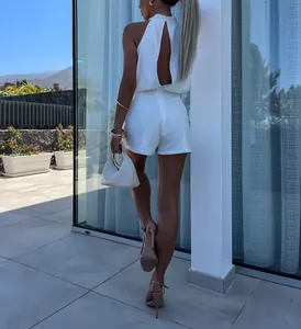 Detailed back view of a chic white sleeveless high neck backless summer romper