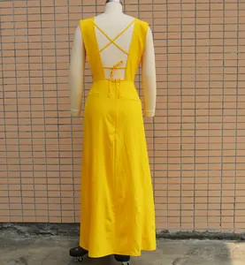 Back view detail of elegant yellow long dress featuring deep V back and cross straps