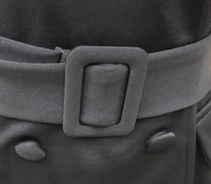 Detail of black office dress featuring fabric covered belt and decorative buttons