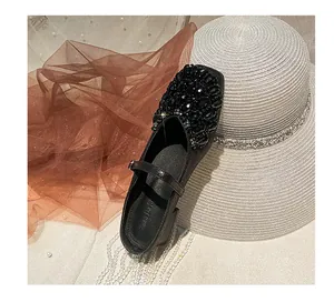 Detailed view of elegant black Mary Jane shoes with luxury black rhinestone bead decor