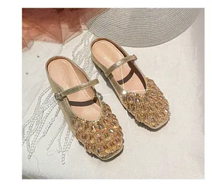 Top view of gold Mary Jane mules with sparkling rhinestone embellished square toes