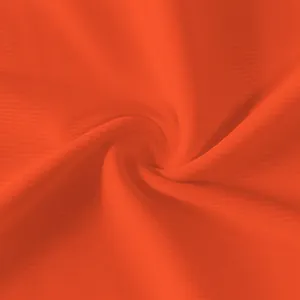 Detailed close-up of bright orange ribbed fabric texture for a slim fit sleeveless dress