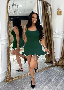 Detail view of a dark green ribbed sleeveless mini dress with white wavy hem and slim fit