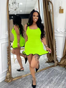 Vibrant lime green sleeveless ribbed mini dress with wavy ruffled hem and black trim detail.