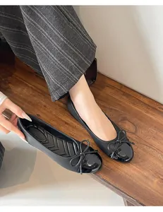 Elegant black ballet flats with glossy patent toe cap and bow detail for women's daily wear