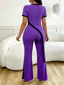 Rear macro view of purple ribbed two-piece set with black contrast asymmetrical strap.