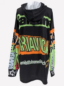 Detail of oversized hoodie dress with neon green and orange graphic lettering.