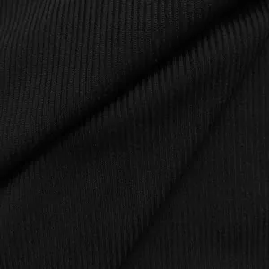 Macro shot of black ribbed stretch fabric showing vertical texture and soft folds.