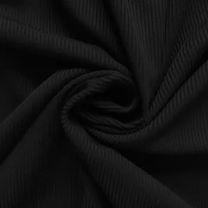 Macro view showing the soft black ribbed fabric texture of the women's jumpsuit.