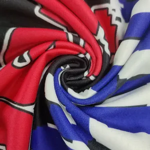Close-up of soft fabric texture with vibrant geometric letter print in red and blue