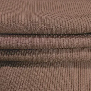 Detail macro view showing the brown ribbed knit fabric texture of a sexy women's bodysuit.