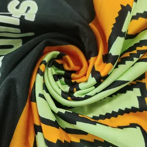 Close-up view of soft knit fabric texture featuring bold neon letter print design
