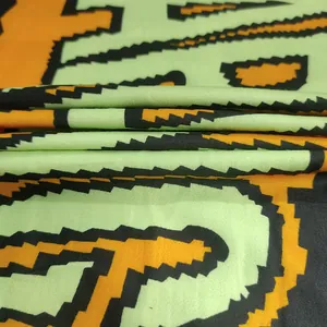 Close-up of the pixelated letter print fabric for a color-blocked hooded T-shirt dress