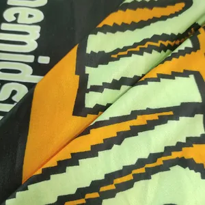 Close-up of vibrant pixelated graphic print on soft oversized hoodie dress fabric