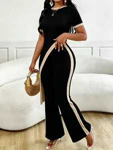 Two-piece black ribbed knit set featuring asymmetrical crop top and high-waisted flare pants