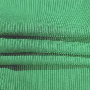 Detailed macro shot of high-quality green ribbed elastic fabric for fashion jumpsuits