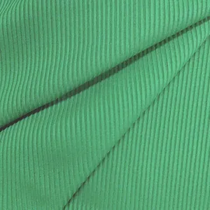 Close-up of green ribbed fabric showing detailed texture and vertical stripes.
