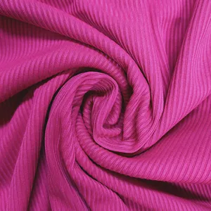 Macro detail of vibrant fuchsia ribbed fabric showing soft texture and elasticity