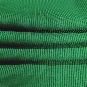 Close-up macro texture detail of high-quality green ribbed fabric for women's wear