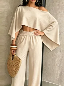 Conjunto de dos piezas beige con top corto de un hombro y pantalones anchos elásticos