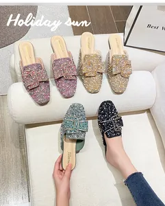Elegant flat pointed-toe mules with shimmering rhinestones in multiple vibrant colors.