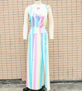 Detailed view of the vibrant rainbow striped maxi dress with high slit and V-neckline.