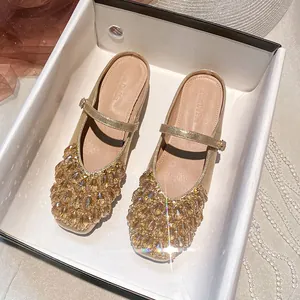 Elegant champagne gold square-toe Mary Jane mules with faceted crystal embellishments.