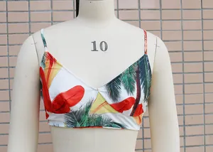Close-up view of a vibrant tropical print bikini top shown on a cream mannequin.