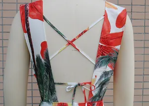 Back detail view of tropical floral dress featuring criss-cross straps and bow tie