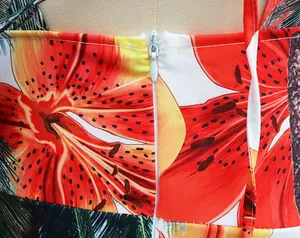 Detailed macro view of invisible back zipper on vibrant orange lily floral print dress