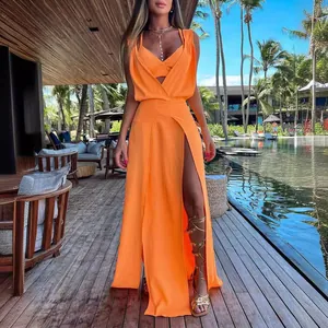 Vibrant orange two-piece set with crop top and high-slit maxi skirt for resort wear