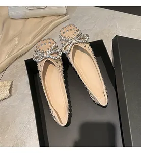 Detailed macro view of luxury rhinestone embellished flat shoes with sparkling bow detail