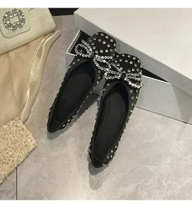 Detail view of black fairy-style flat shoes featuring elegant full rhinestone bow